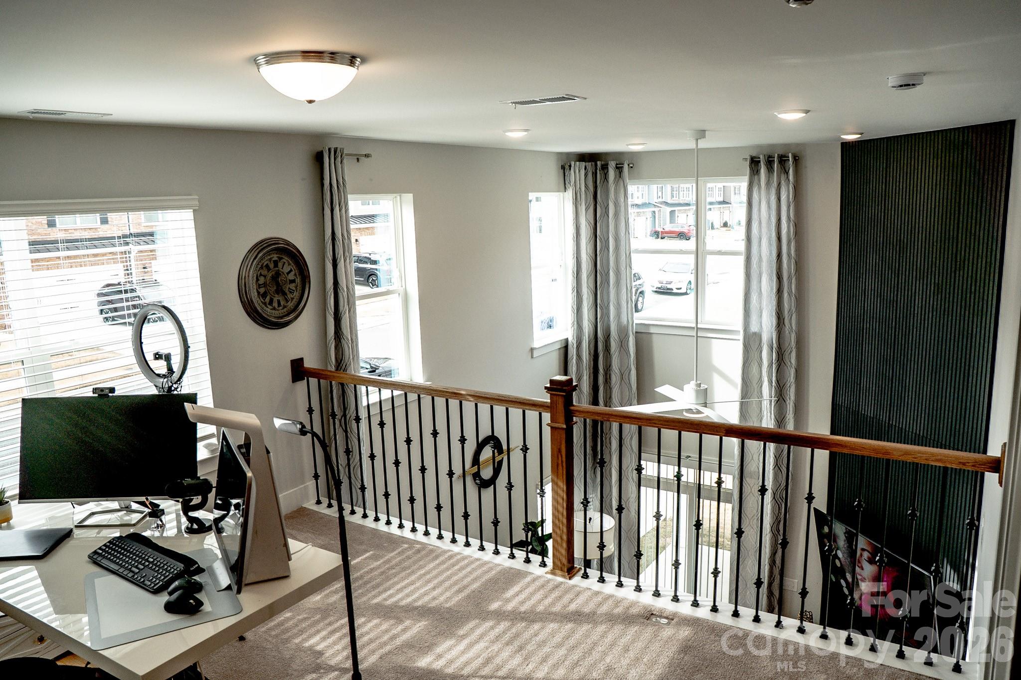 6288 Culbert Street Harrisburg, NC 28075 - Photo 23 of 40 a view of a hallway with workspace and windows