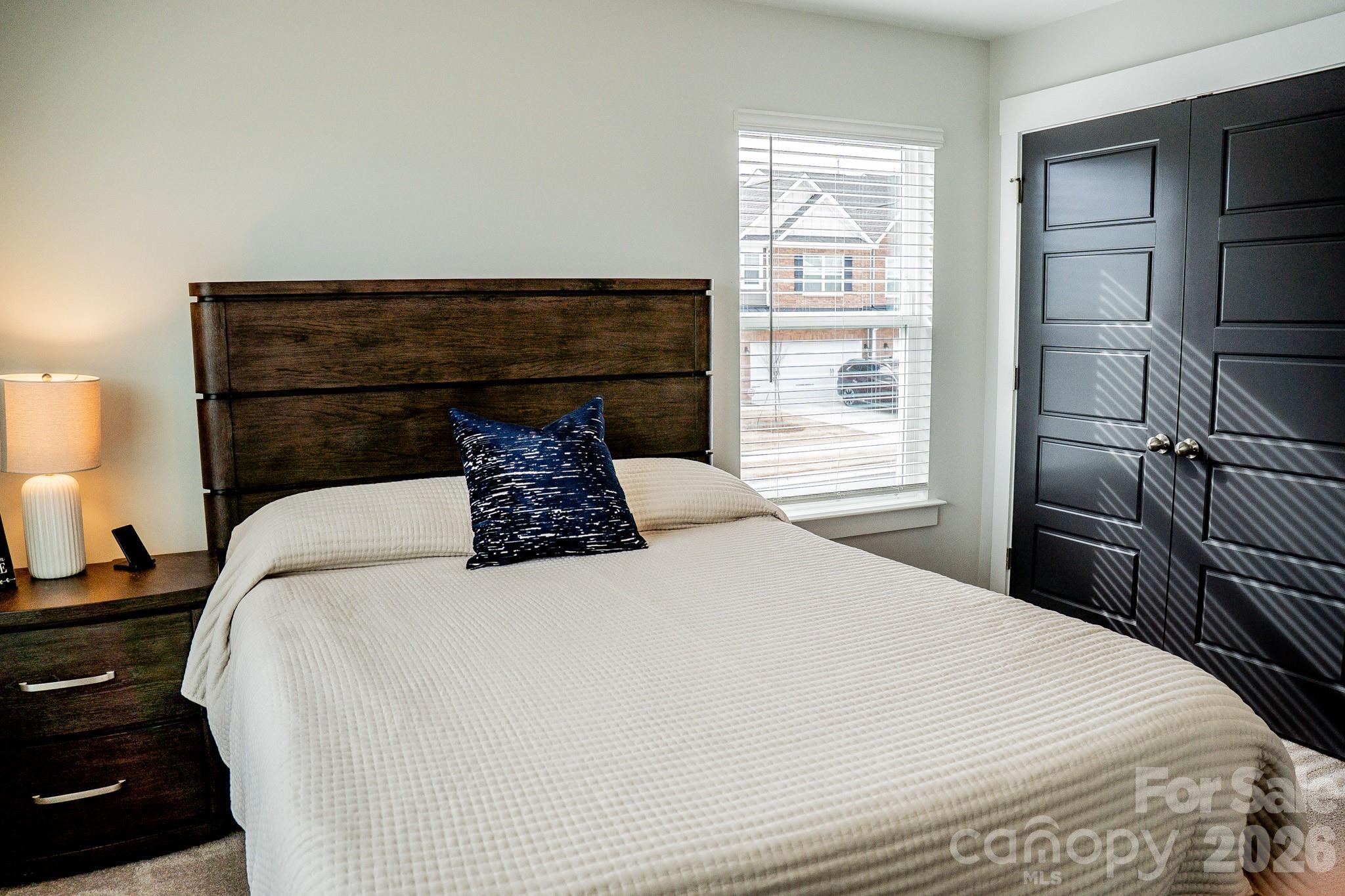 6288 Culbert Street Harrisburg, NC 28075 - Photo 26 of 40 a bedroom with a bed and wooden floor