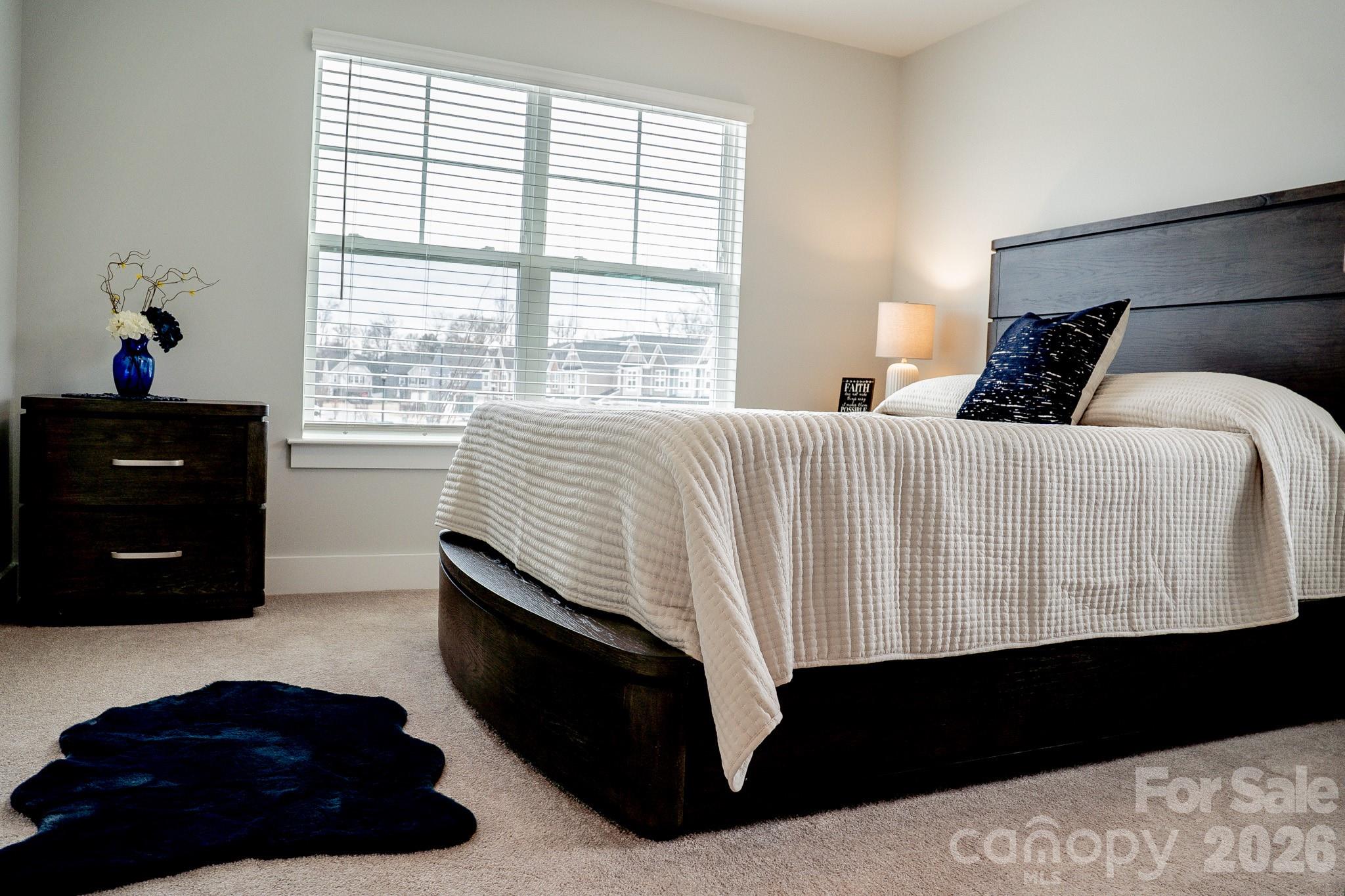 6288 Culbert Street Harrisburg, NC 28075 - Photo 27 of 40 a bedroom with a bed a dresser and a window
