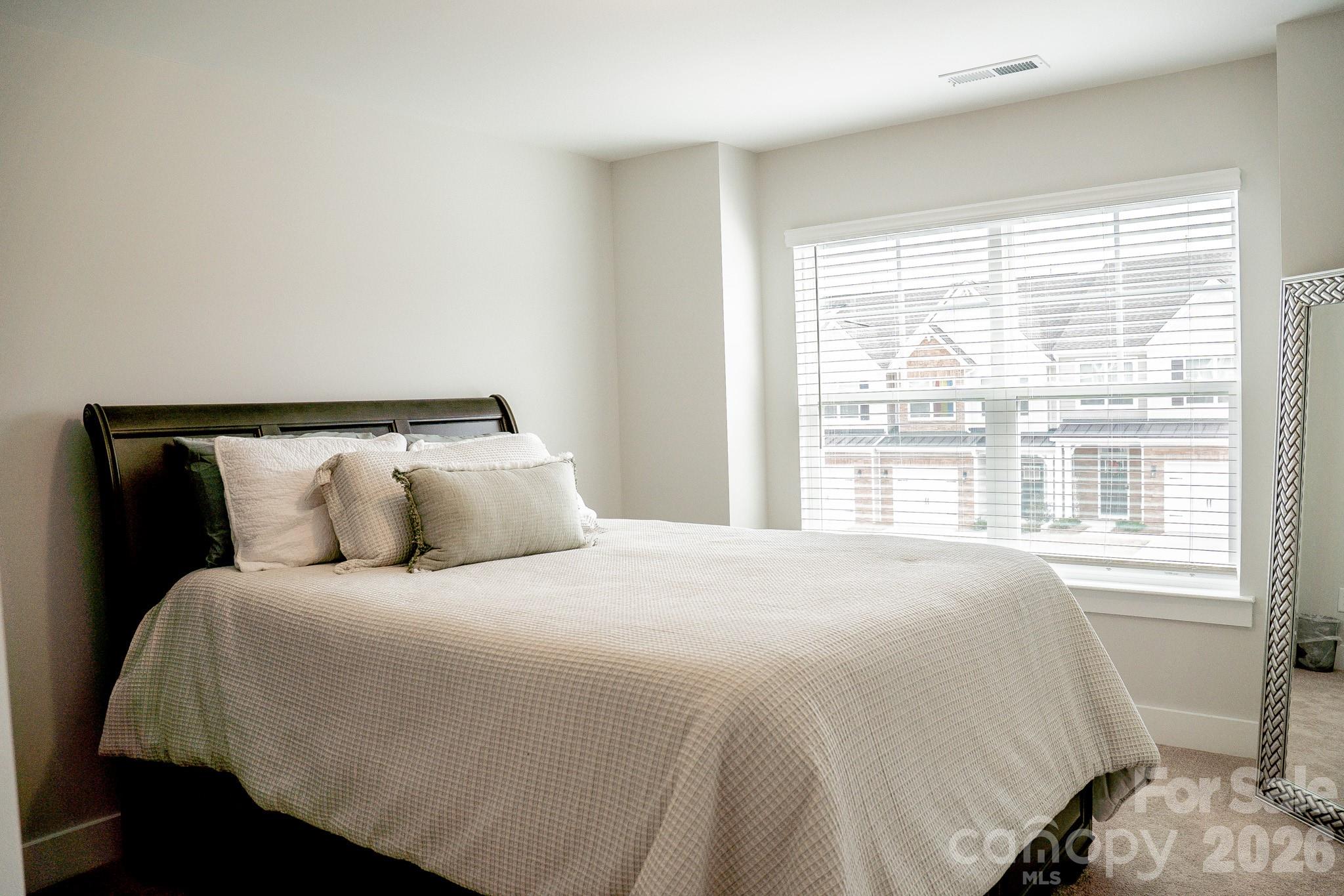 6288 Culbert Street Harrisburg, NC 28075 - Photo 28 of 40 a large bed sitting in a bedroom next to a window