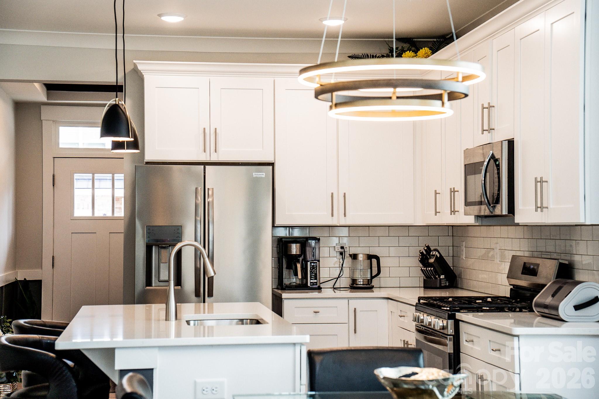 6288 Culbert Street Harrisburg, NC 28075 - Photo 8 of 40 a kitchen with stainless steel appliances kitchen island granite countertop a sink and a stove