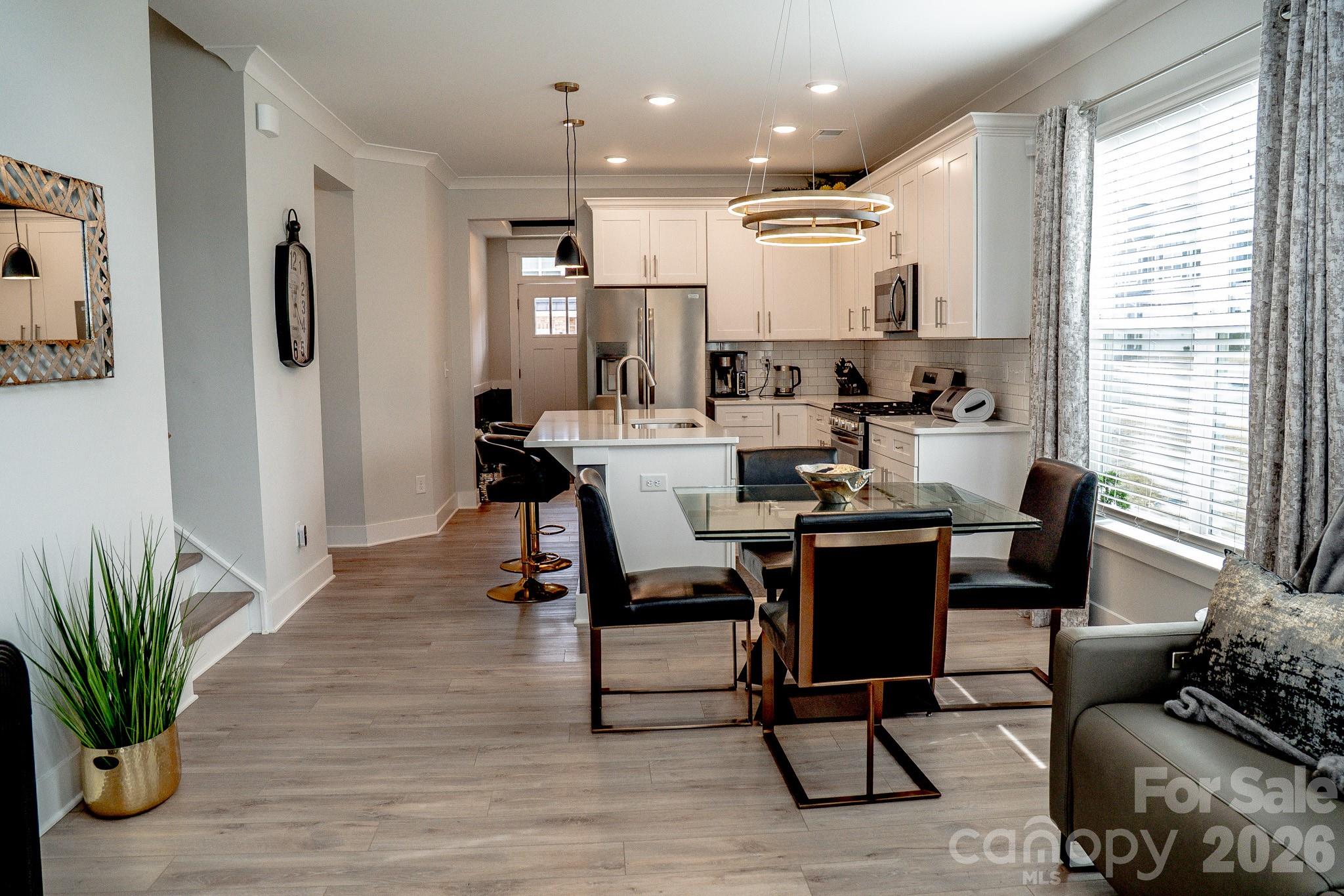 6288 Culbert Street Harrisburg, NC 28075 - Photo 9 of 40 a view of a dining room with furniture and wooden floor
