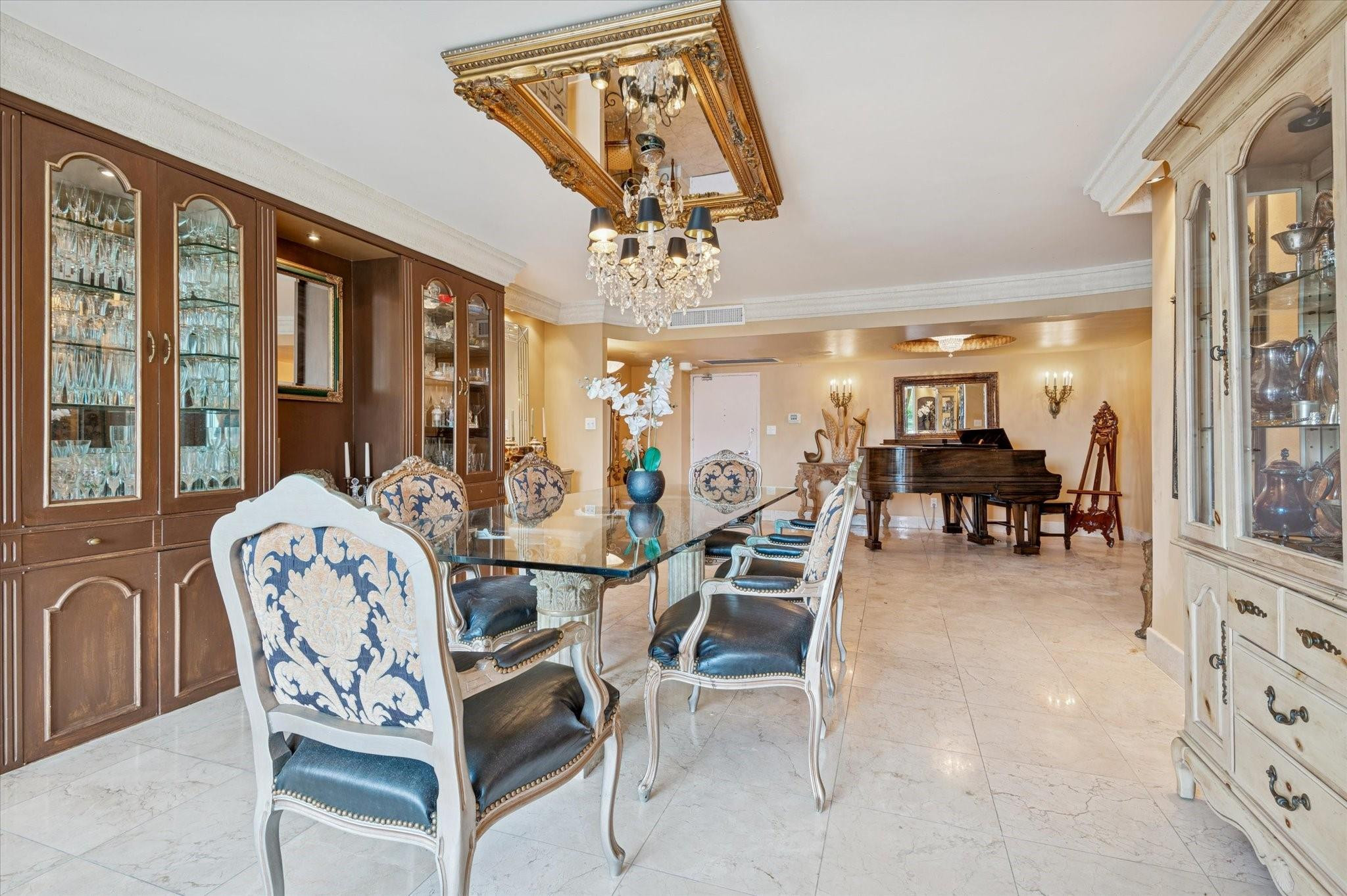5151 Collins Avenue, Unit 520 Miami Beach, FL 33140 - Photo 6 of 14 a dining room with furniture garden view and a chandelier