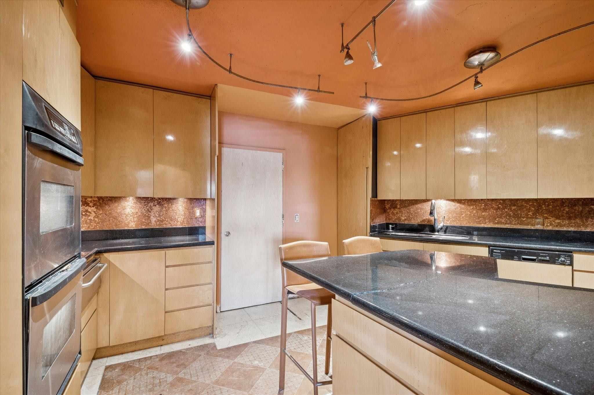 5151 Collins Avenue, Unit 520 Miami Beach, FL 33140 - Photo 7 of 14 a kitchen with stainless steel appliances granite countertop a sink and a refrigerator
