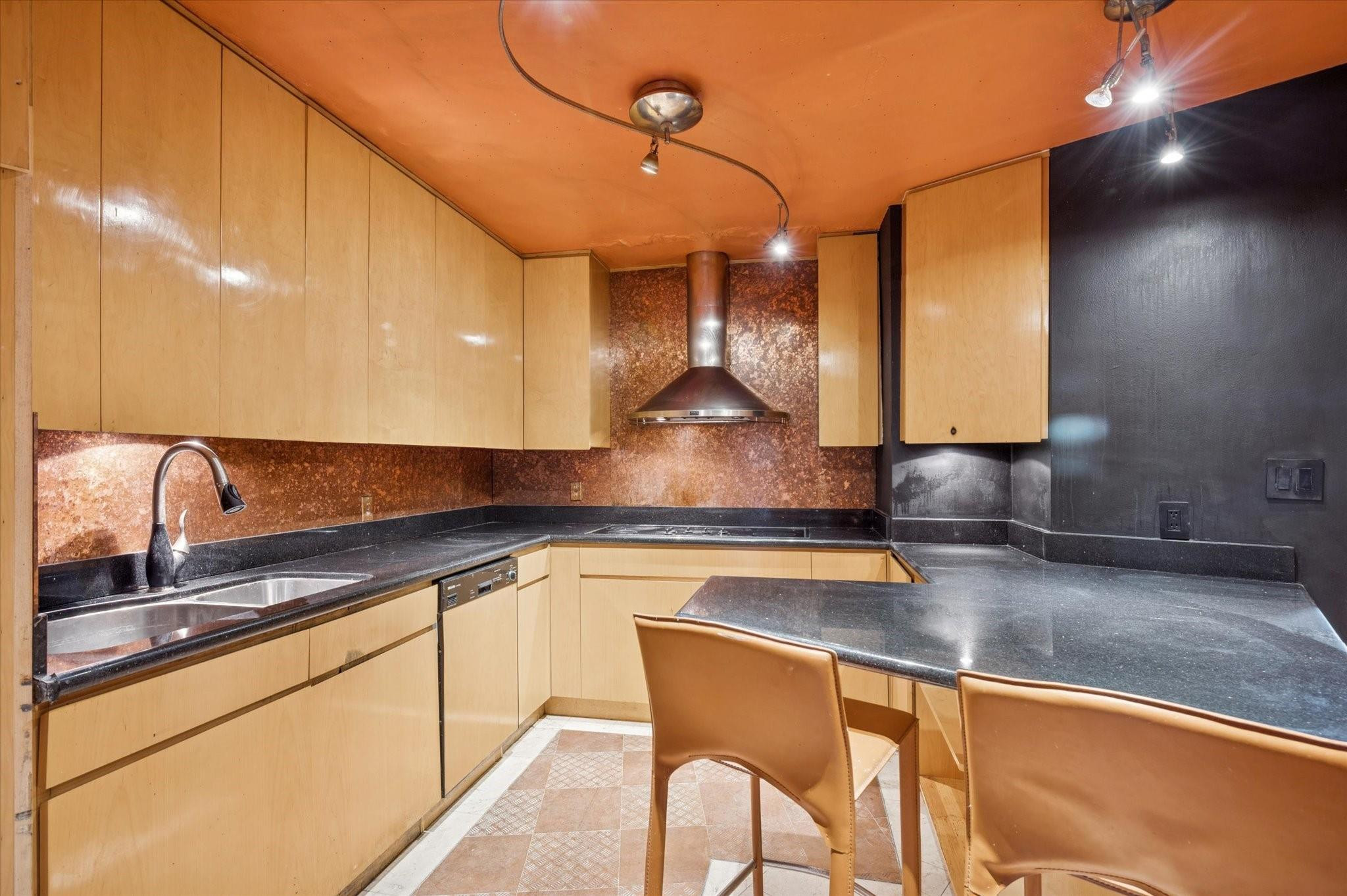 5151 Collins Avenue, Unit 520 Miami Beach, FL 33140 - Photo 8 of 14 a kitchen with stainless steel appliances granite countertop a sink and cabinets