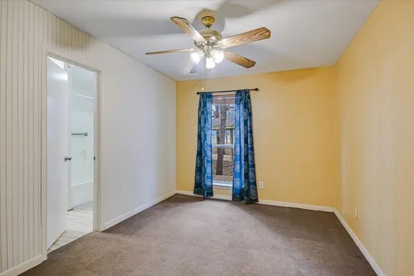 a view of an empty room with a ceiling fan