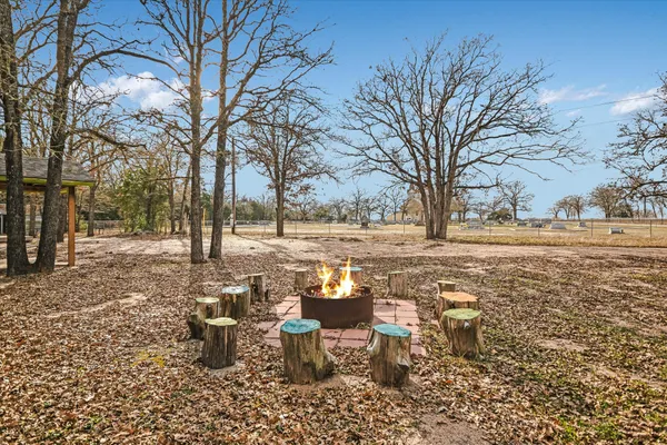 a view of a yard with a table and chairs