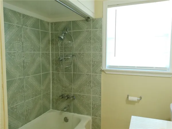 a bathroom with a shower and a toilet sink