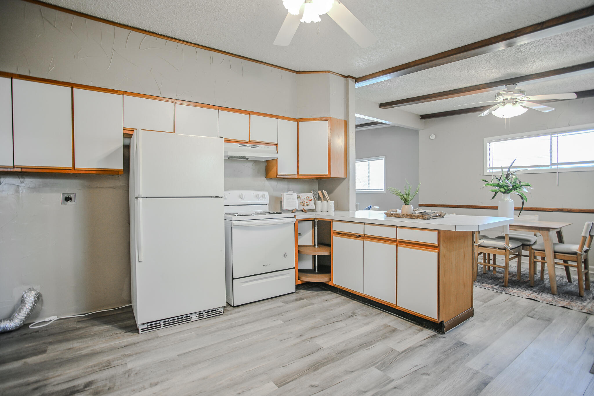 4405 44th Street Lubbock, TX 79414 - Photo 11 of 28 a kitchen with white cabinets and white appliances