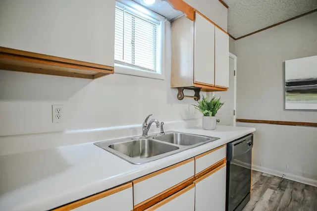 a kitchen with a sink cabinets and window