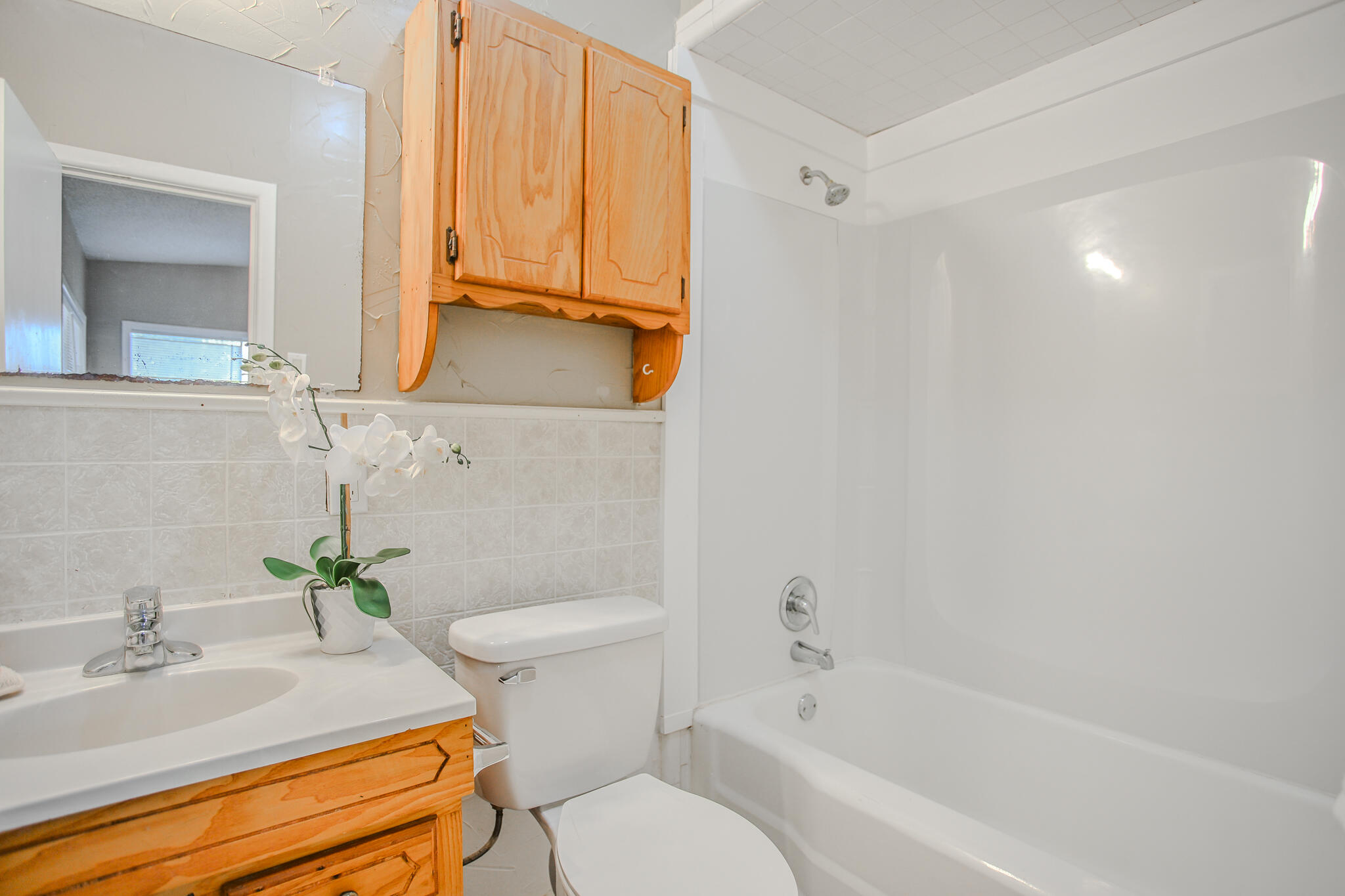 4405 44th Street Lubbock, TX 79414 - Photo 19 of 28 a bathroom with a sink toilet and shower