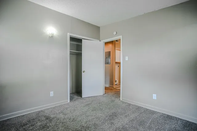 an empty room with windows and entrance