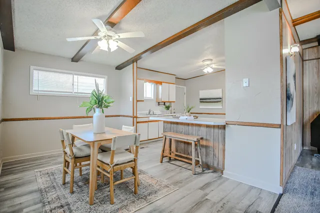 a view of a dining room with furniture and window