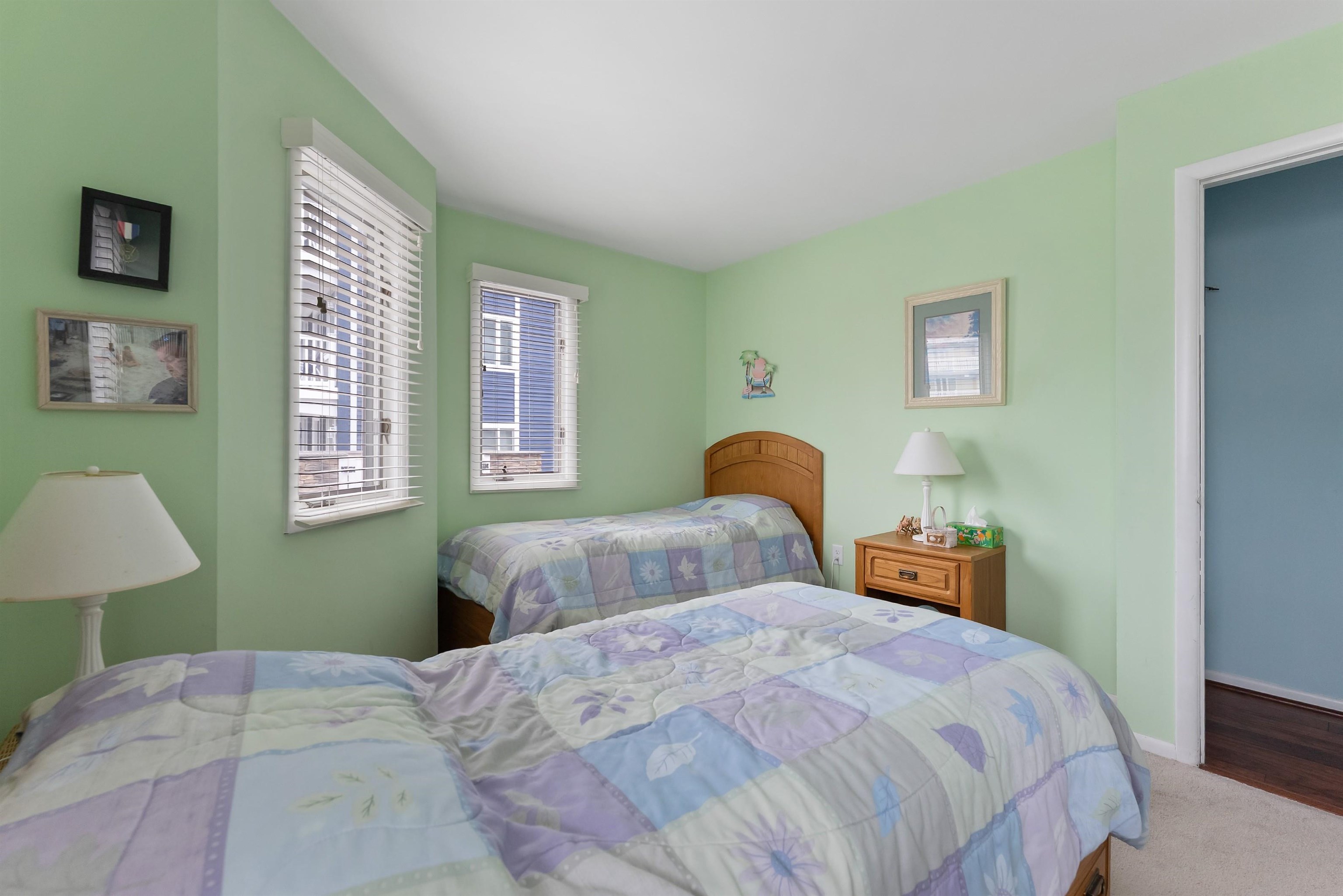 280 79th Street, Unit 1 Avalon, NJ 08202 - Photo 17 of 21 a bedroom with a bed and a lamp on dresser
