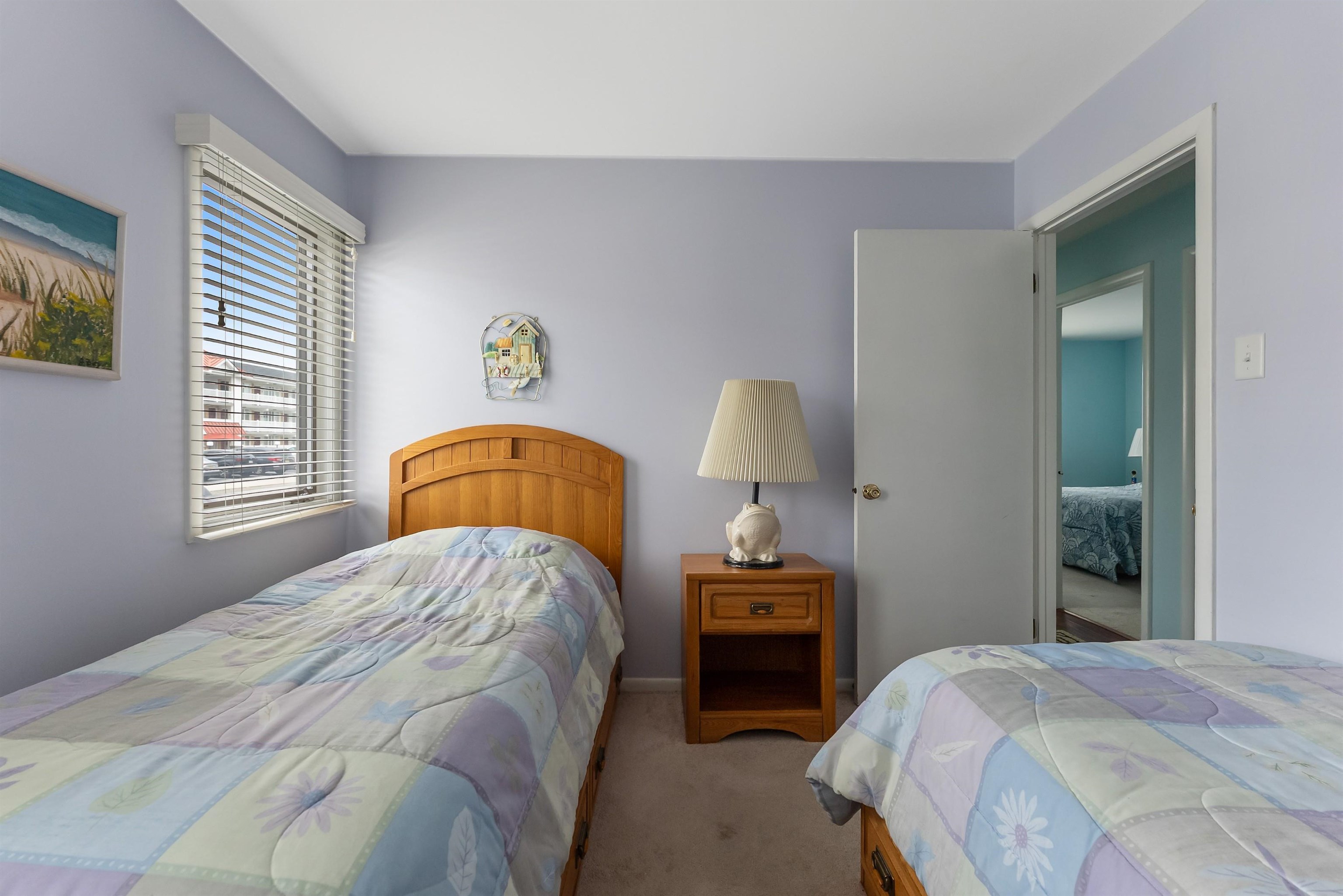 280 79th Street, Unit 1 Avalon, NJ 08202 - Photo 19 of 21 a bedroom with a bed and a window