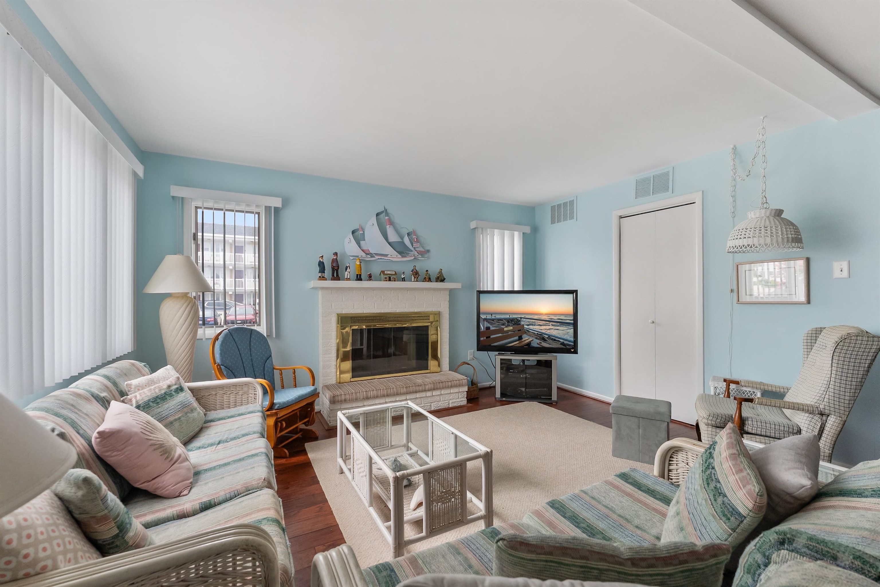 280 79th Street, Unit 1 Avalon, NJ 08202 - Photo 3 of 21 a living room with furniture a fireplace and a window