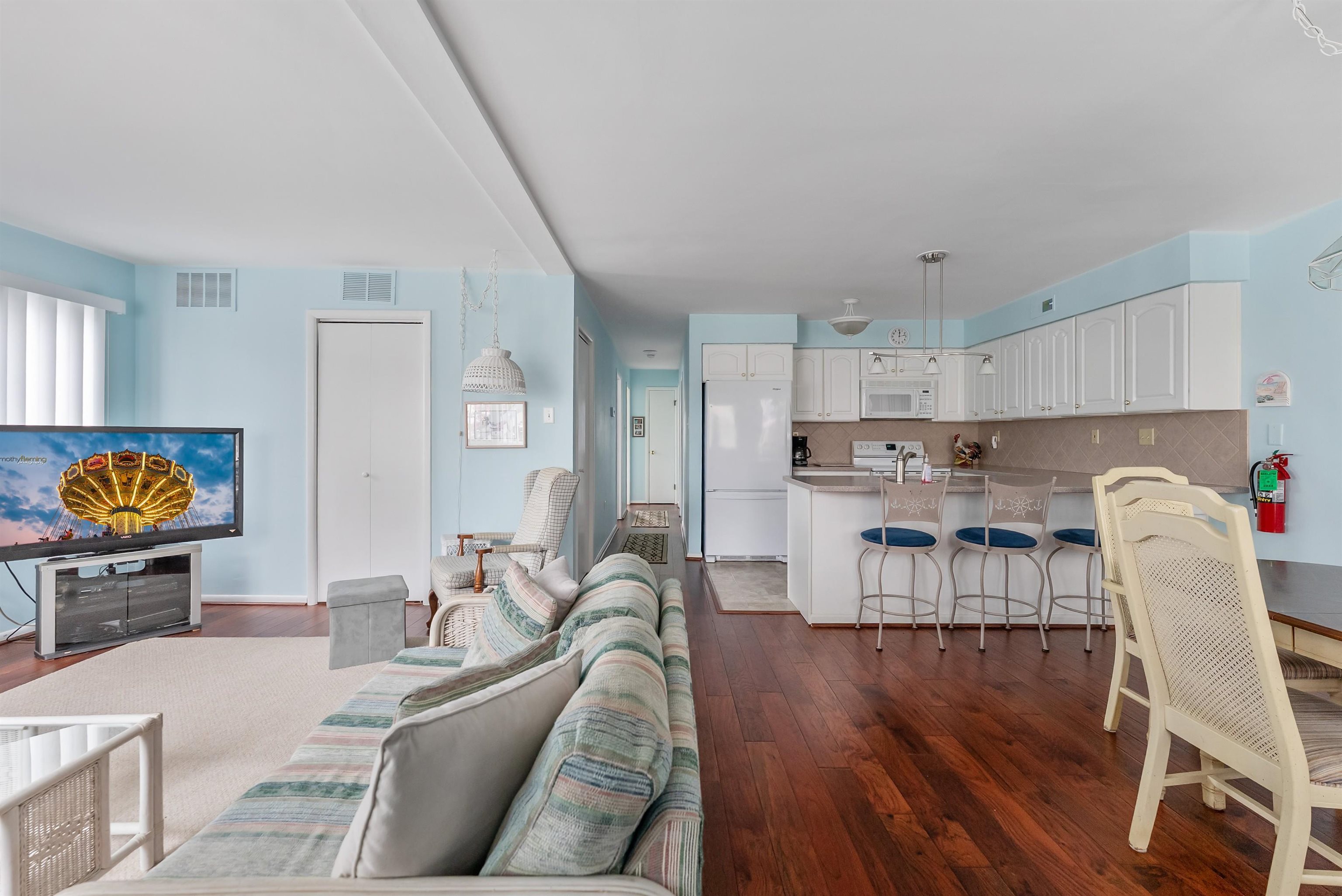 280 79th Street, Unit 1 Avalon, NJ 08202 - Photo 9 of 21 a living room with stainless steel appliances furniture and a wooden floor