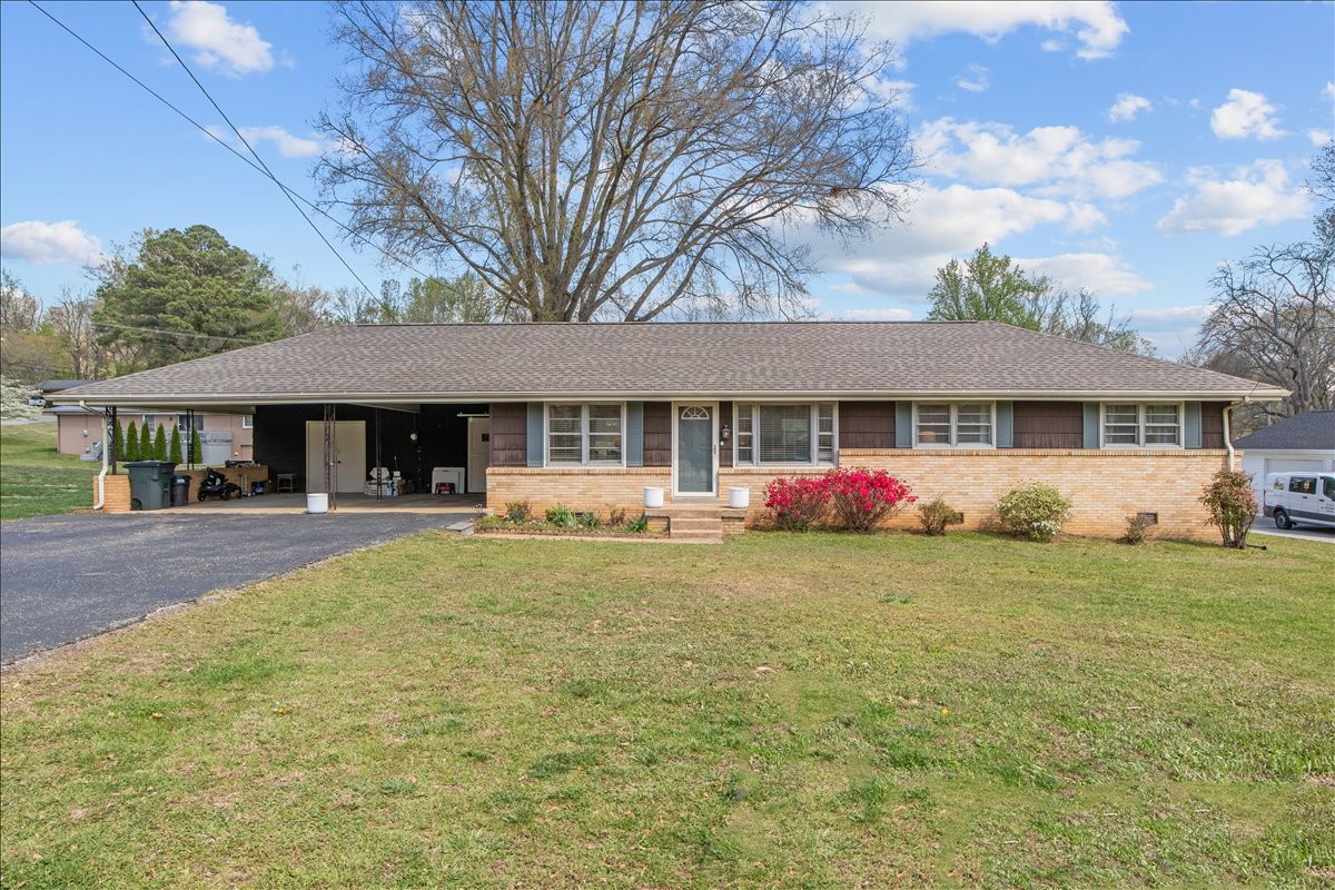 a front view of a house with yard and porch