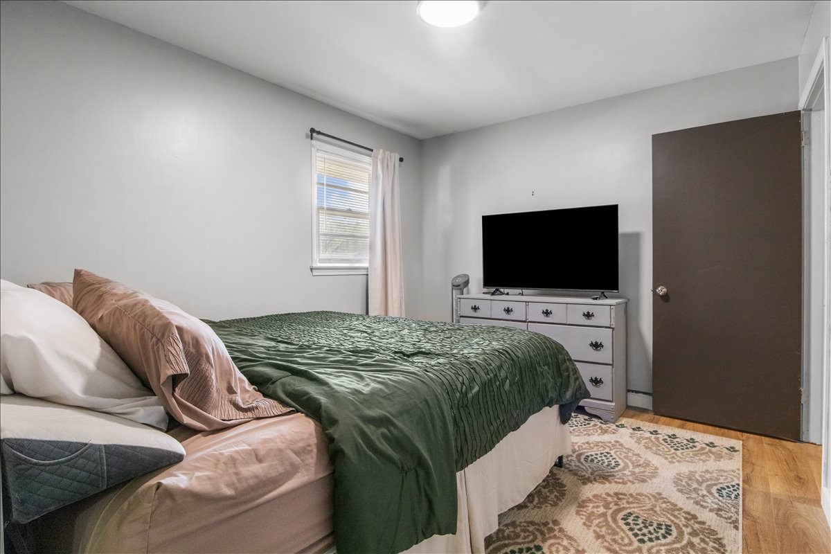1112 Bridgette Street Paris, TN 38242 - Photo 16 of 34 a bedroom with a bed and a flat screen tv