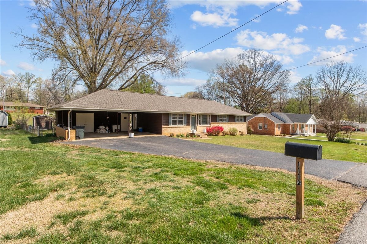 1112 Bridgette Street Paris, TN 38242 - Photo 2 of 34 a front view of a house with a yard