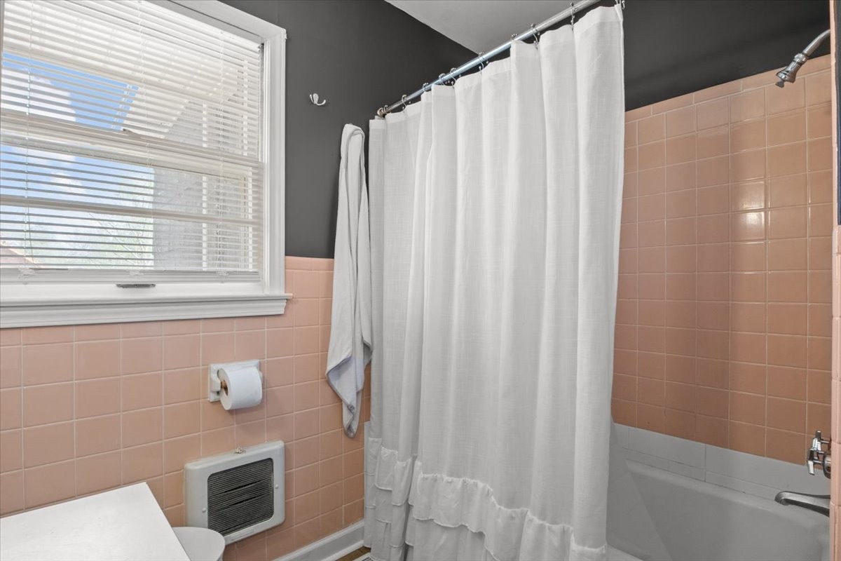 1112 Bridgette Street Paris, TN 38242 - Photo 23 of 34 a bathroom with a shower curtain and a window