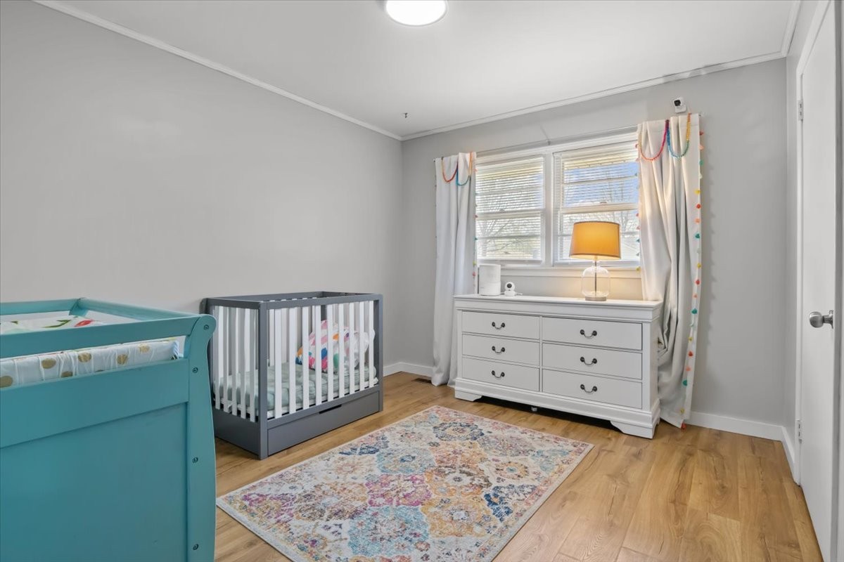 1112 Bridgette Street Paris, TN 38242 - Photo 24 of 34 a view of a bedroom with baby crib and dresser