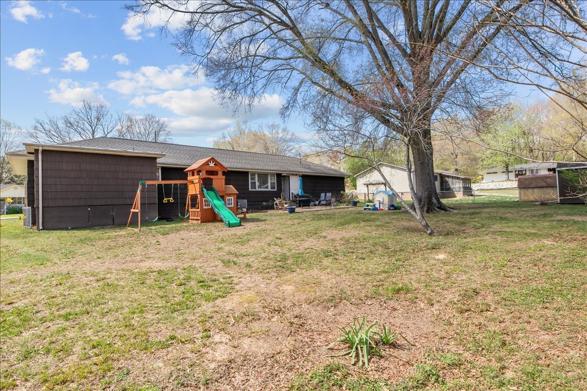 1112 Bridgette Street Paris, TN 38242 - Photo 32 of 34 a view of a house with a yard and garage