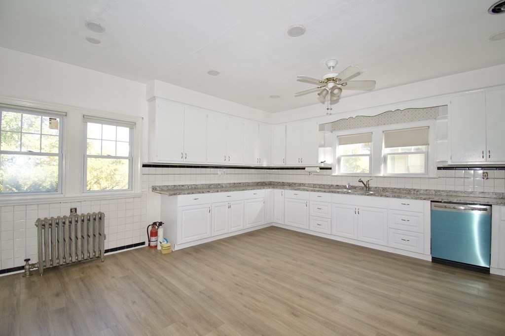 102 Florence Street Springfield, MA 01105 - Photo 12 of 30 a kitchen with stainless steel appliances granite countertop a sink cabinets and wooden floor