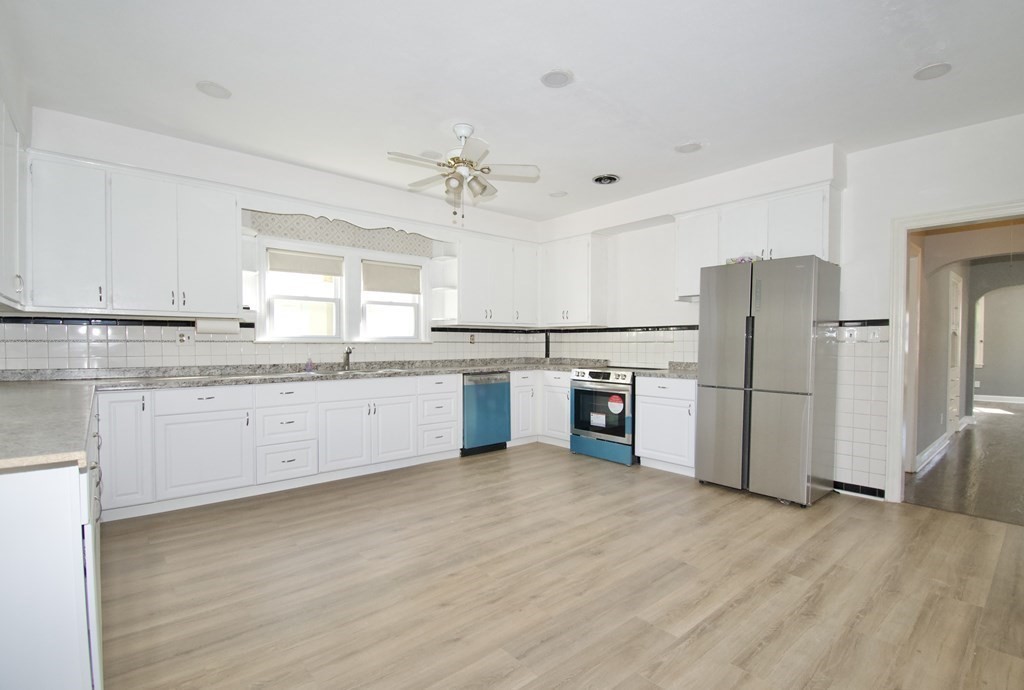 102 Florence Street Springfield, MA 01105 - Photo 14 of 30 a kitchen with stainless steel appliances a refrigerator sink and cabinets