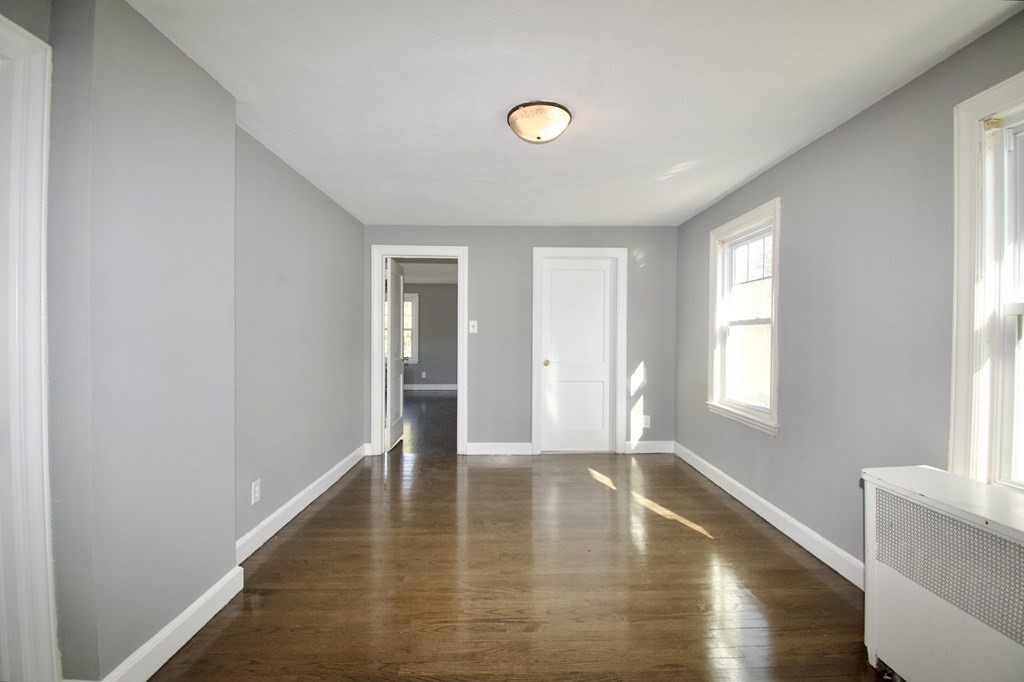 102 Florence Street Springfield, MA 01105 - Photo 18 of 30 a view of empty room with wooden floor and fan
