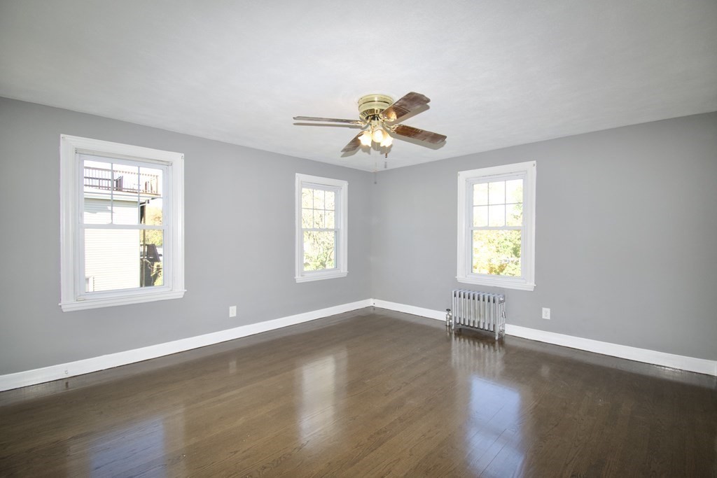 102 Florence Street Springfield, MA 01105 - Photo 19 of 30 a view of an empty room with a window and wooden floor
