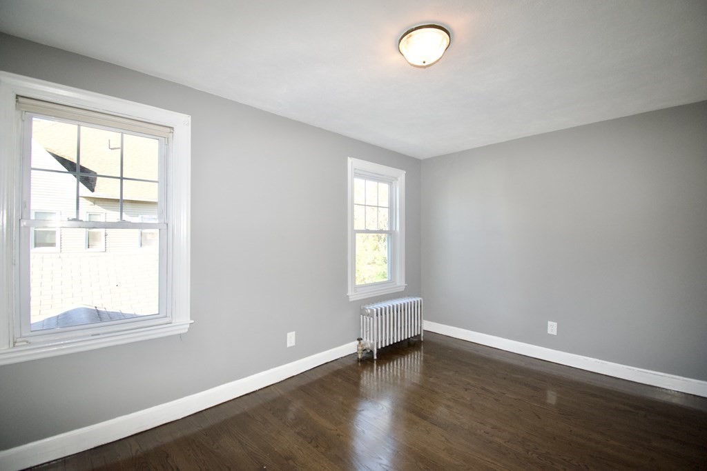 102 Florence Street Springfield, MA 01105 - Photo 20 of 30 an empty room with wooden floor and windows
