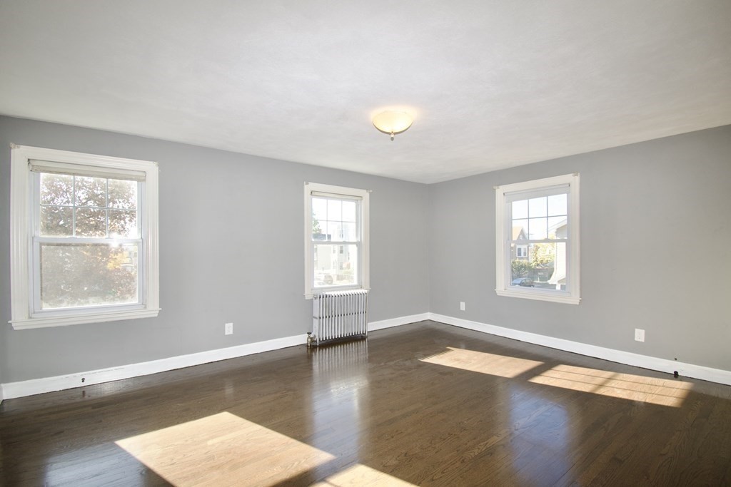102 Florence Street Springfield, MA 01105 - Photo 22 of 30 a view of an empty room with wooden floor and a window