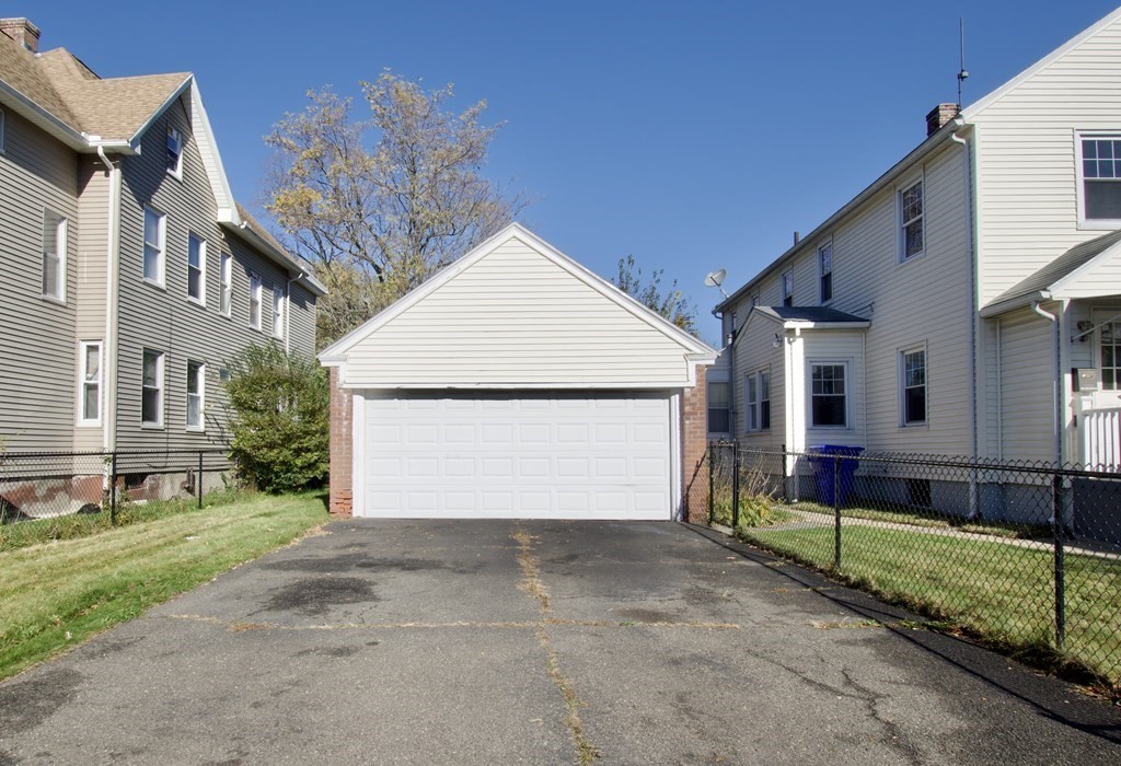 102 Florence Street Springfield, MA 01105 - Photo 3 of 30 a view of a house with a yard and garage