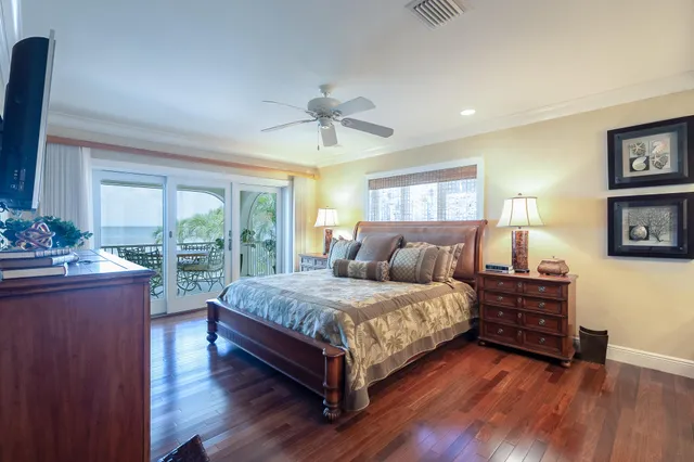 a large bedroom with a bed and wooden floor