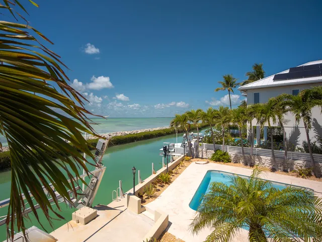 a view of a swimming pool with a patio and a yard