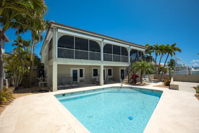 a view of swimming pool with a table and chairs