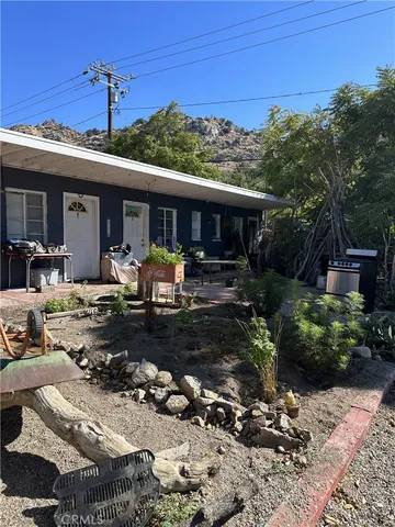 a view of a house with backyard sitting area and garden