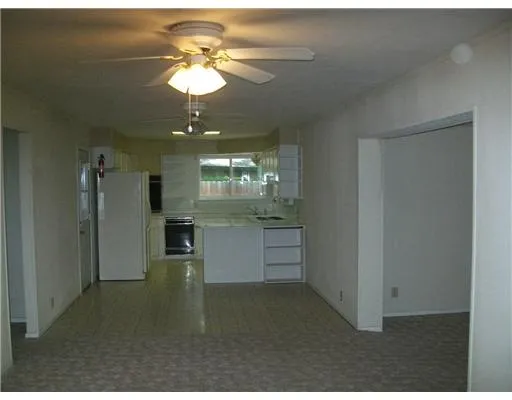 a kitchen that has a lot of cabinets and appliances