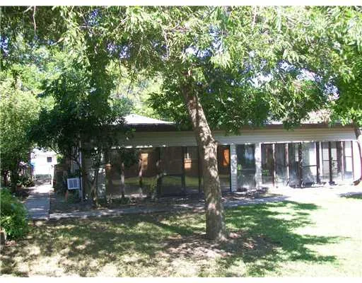 a backyard of a house with yard and outdoor seating