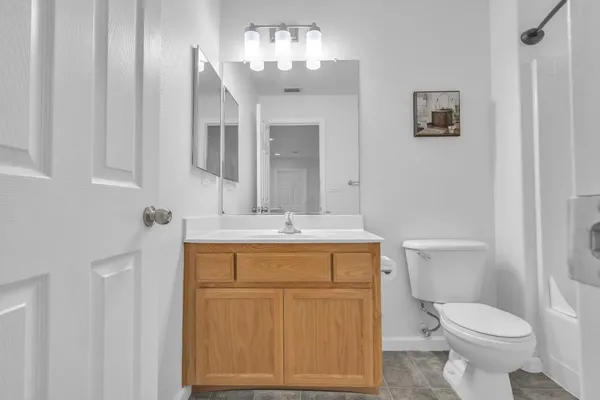 a bathroom with a toilet a sink and mirror