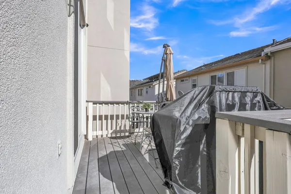 a view of balcony with wooden floor and fence