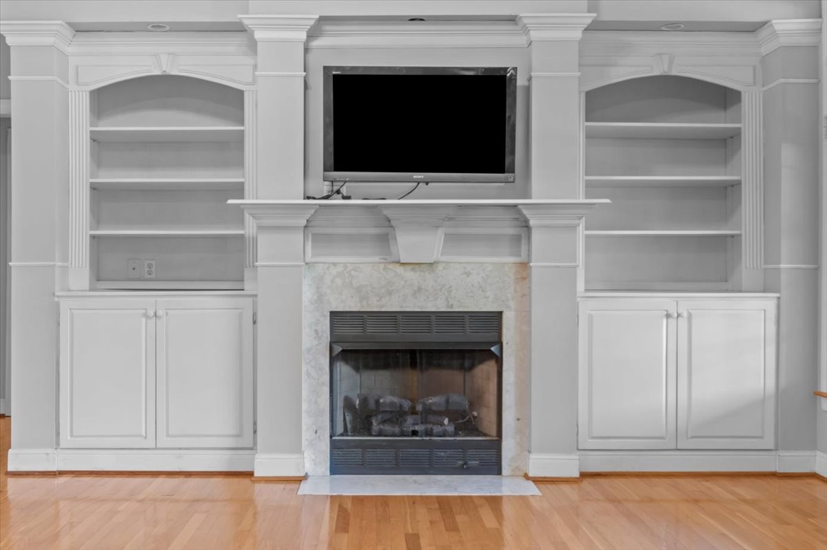 2440 Maple Grove Road Dickson, TN 37055 - Photo 11 of 87 a living room with a fireplace and a flat screen tv