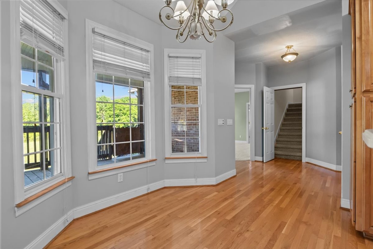 2440 Maple Grove Road Dickson, TN 37055 - Photo 13 of 87 a view of an empty room with wooden floor and a window