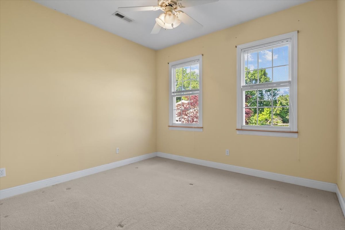 2440 Maple Grove Road Dickson, TN 37055 - Photo 26 of 87 an empty room with windows and chandelier fan
