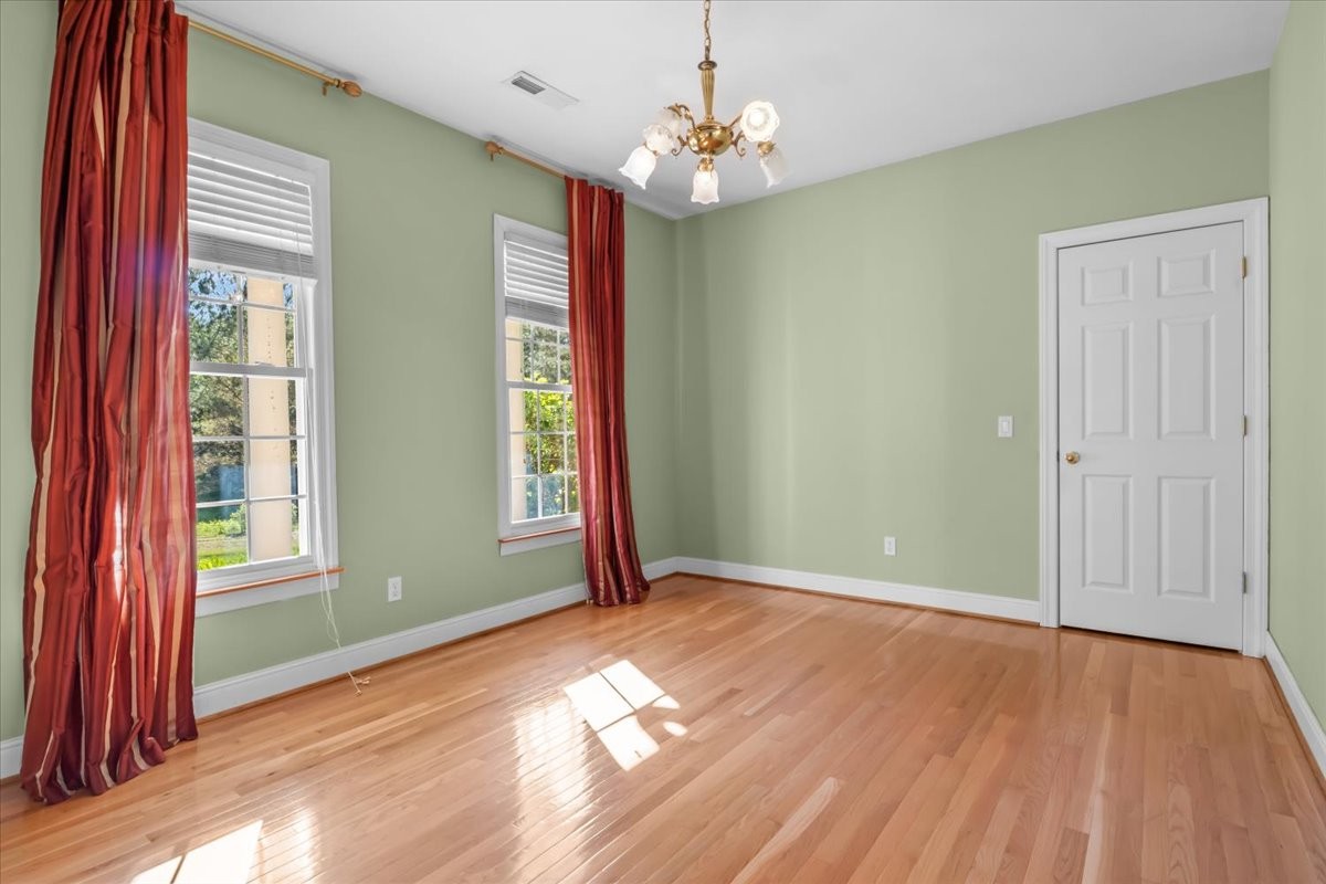 2440 Maple Grove Road Dickson, TN 37055 - Photo 6 of 87 an empty room with wooden floor chandelier and windows