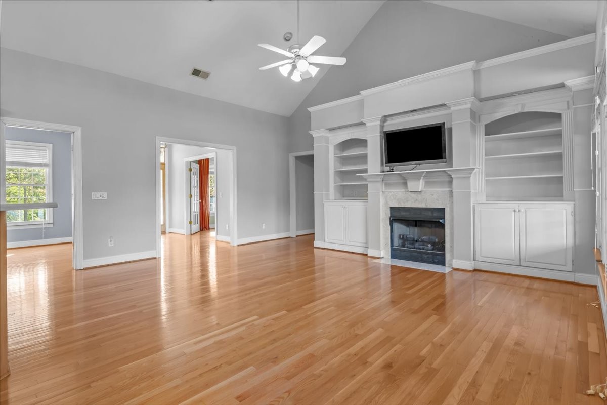 2440 Maple Grove Road Dickson, TN 37055 - Photo 10 of 87 a view of a livingroom with a flat screen tv wooden floor and a ceiling fan