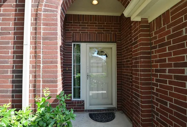 an empty room with windows and fireplace