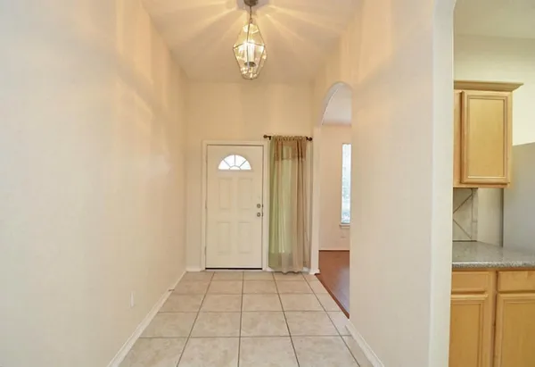 a view of a kitchen with granite countertop white cabinets and a stove