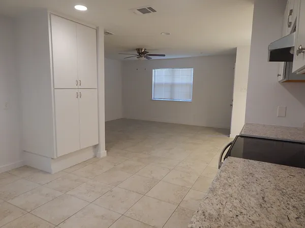 an empty room with windows and closet